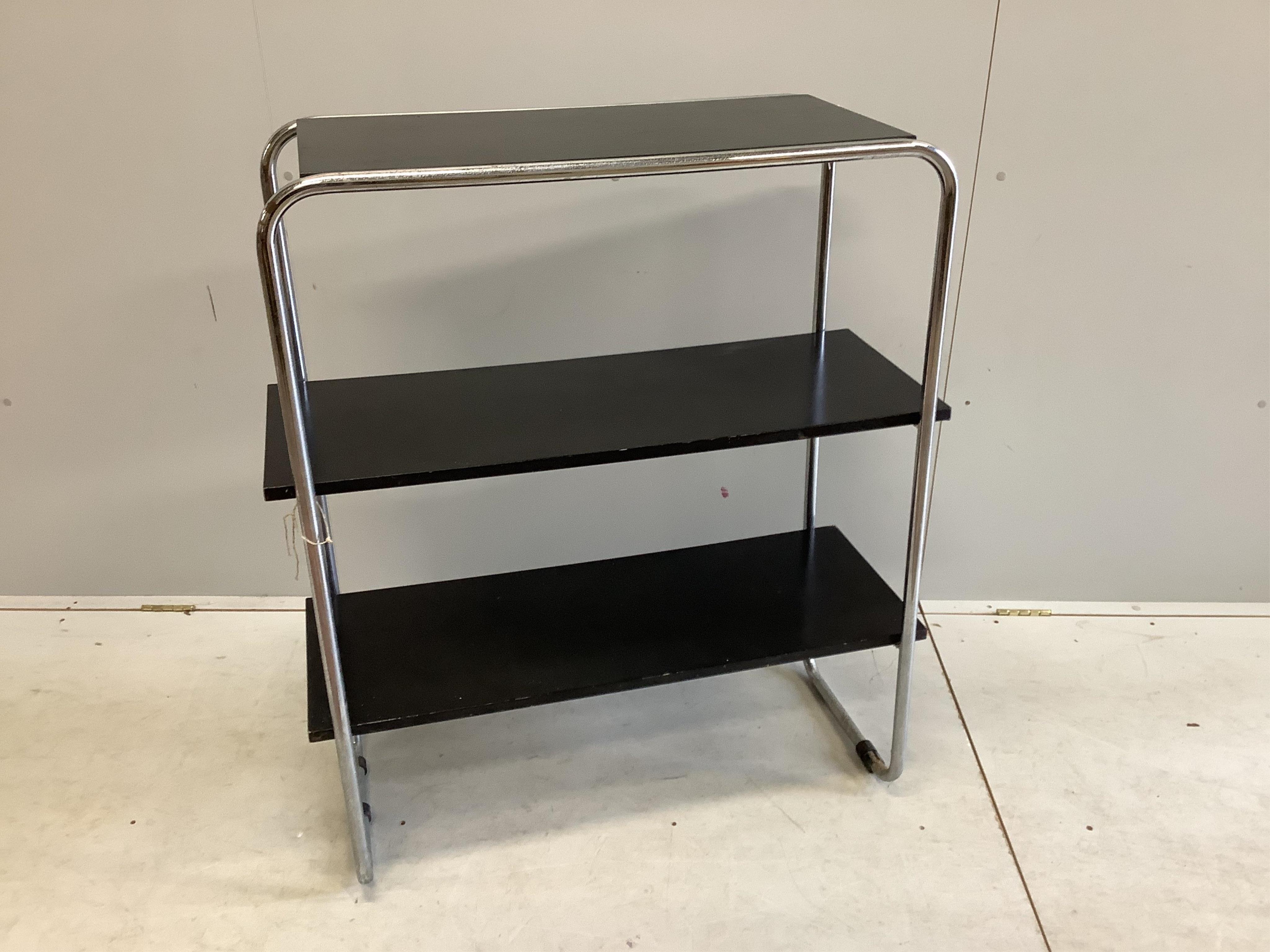 A mid century black lacquer and chrome three tier shelf unit, width 93cm, depth 38cm, height 107cm. Condition - poor to fair